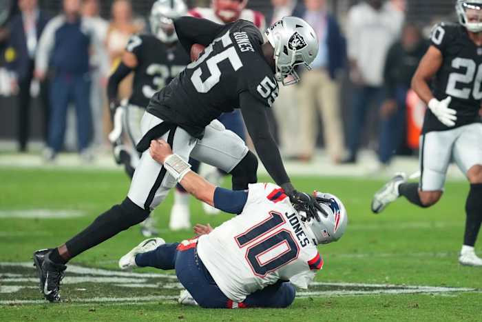 Raiders defensive end Chandler Jones pushes down Patriots quarterback Mac Jones and races to the end zone on the final play of the game for the win.